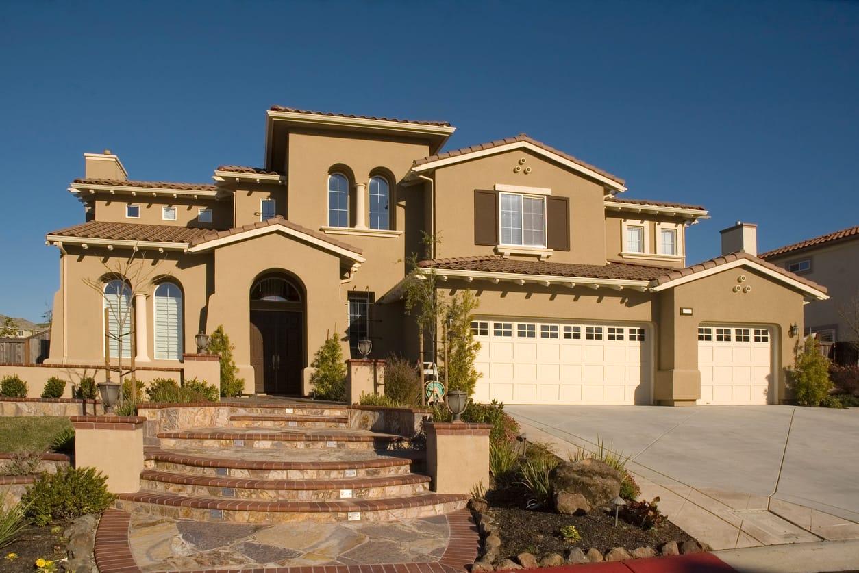 Stucco and stone home exterior by Champion Plastering